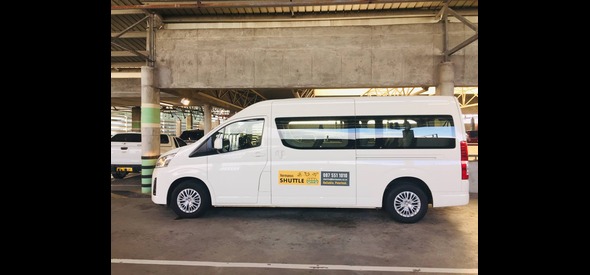 Hermanus Shuttle minivan parked in an airport parking garage