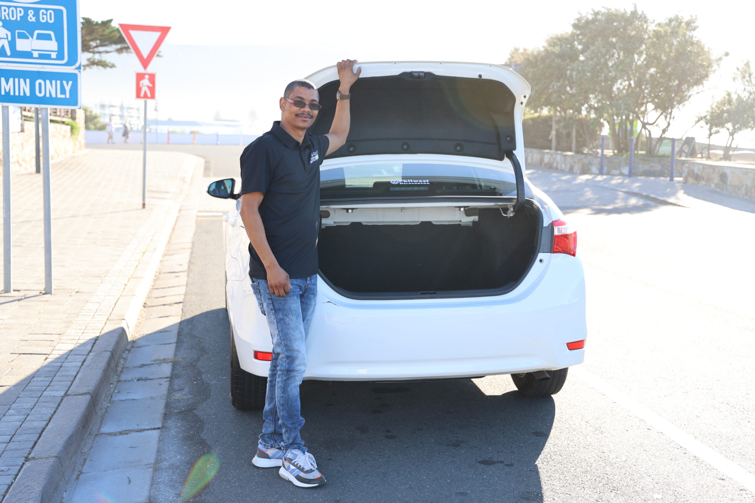 Hermanus Shuttle sedan with driver loading luggage